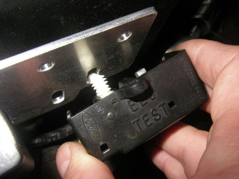 1990 Ford Bronco - A hand holds a black Ford relay part with 'TEST' visible.