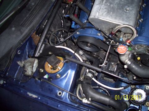 1995 Ford Probe - The engine bay shows a complex arrangement of parts, including a timing belt and various fluid lines.