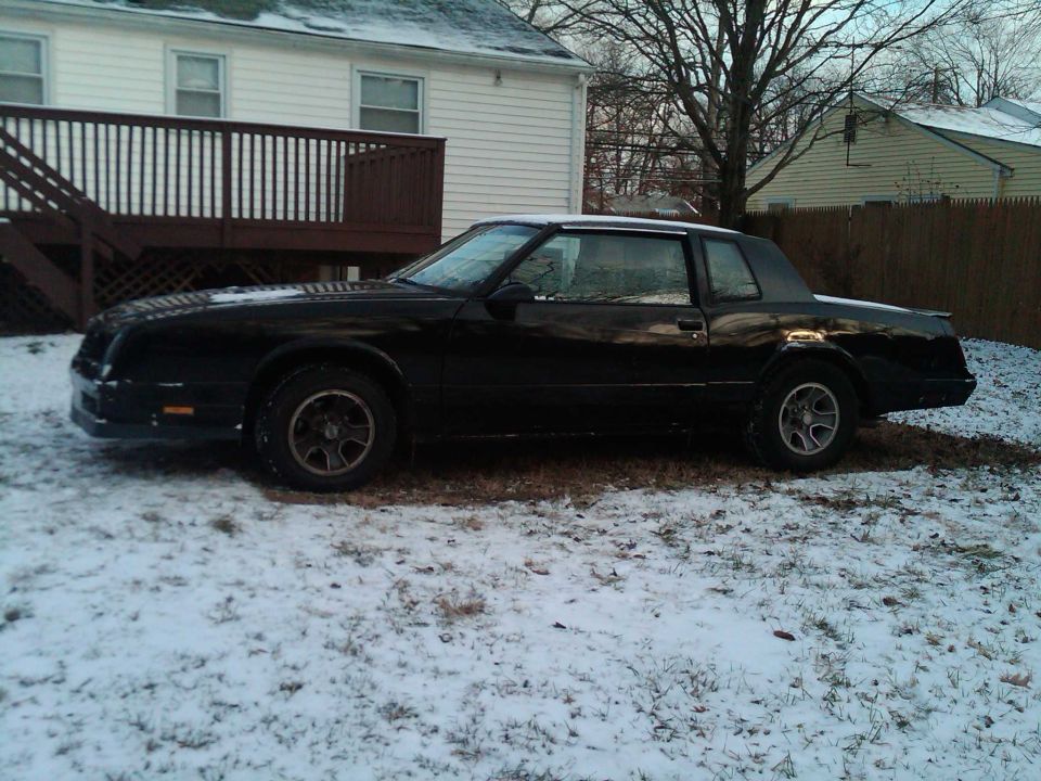 Black 1988 Chevrolet Monte Carlo coupe parked in a snowy yard