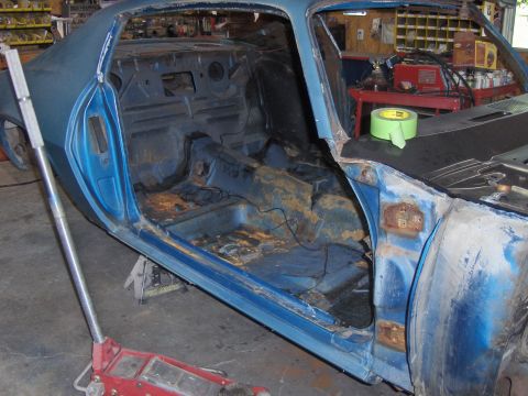 1970 Chevrolet Camaro - This blue coupe is undergoing restoration, with its interior stripped bare and body showing signs of rust.