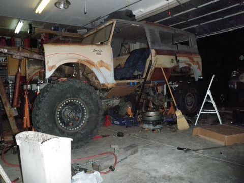 1961 International Scout 800 - This 1961 International Scout 800 is in a garage, appearing to be modified with large tires and suspension work.