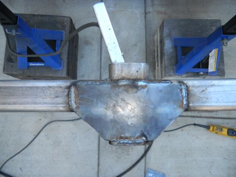1997 Ford Ranger - A custom metal part, likely for fabrication, is secured with blue clamps and wooden blocks.