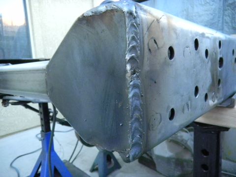 1997 Ford Ranger - A close-up view of a fabricated metal frame section, showing extensive welding and drilled holes.