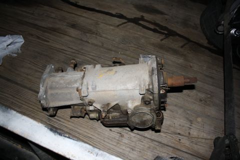 1984 Ford Bronco II - A transmission part is shown resting on a wooden surface, possibly for an engine or drivetrain swap.