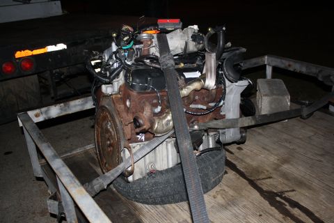1984 Ford Bronco II - Engine assembly being transported on a flatbed trailer.