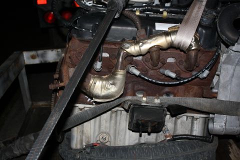 1984 Ford Bronco II - Close-up view of an engine, showing the exhaust manifold and spark plug wires, with "Supermotors.net" visible at the bottom.