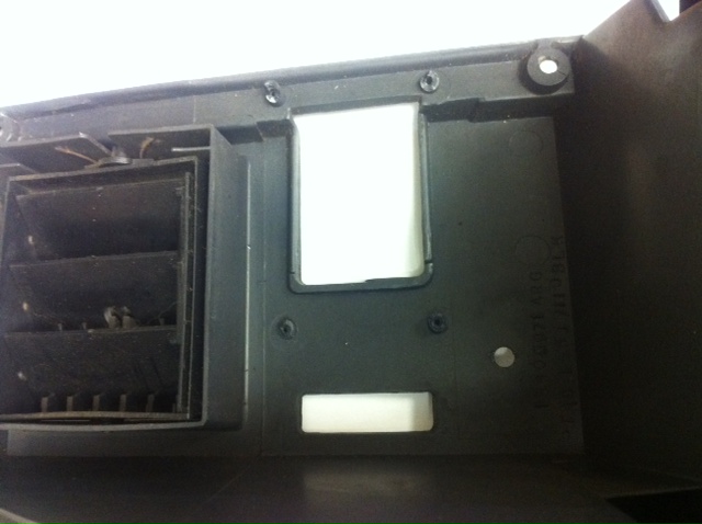 Dashboard vent and panel with visible text and mounting holes
