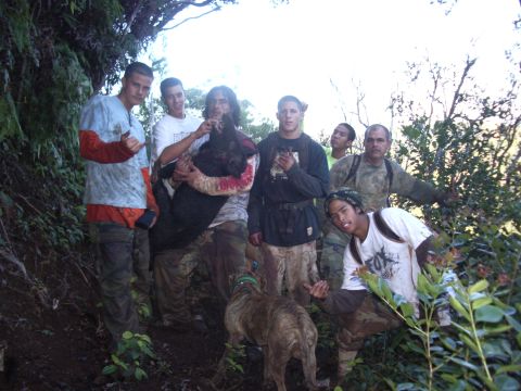 1991 Ford Bronco - A group of men pose with a large dead animal and a dog in a wooded, outdoor setting.