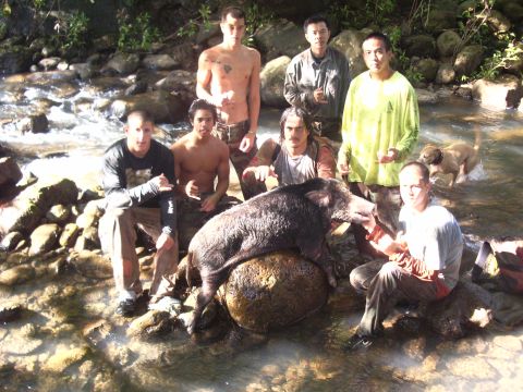 1991 Ford Bronco - A group of men and a dog pose with a large wild boar in a shallow stream.