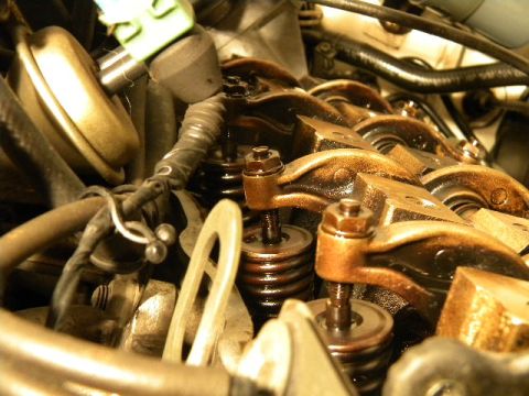 1988 Ford Bronco - Close-up view of an engine's internal components, focusing on the valve train mechanism.