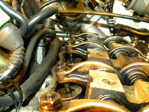 1988 Ford Bronco - Engine valve train components are visible in this close-up shot, with oil present on the metal parts.
