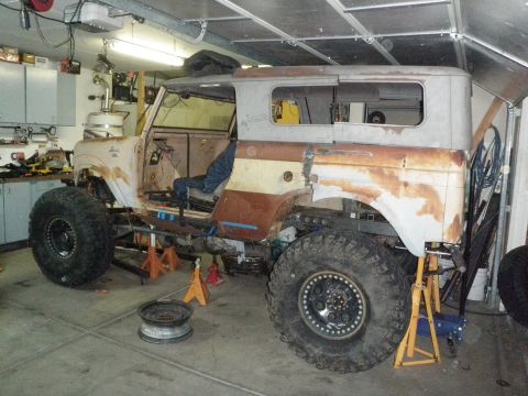 1961 International Scout 800 - 1961 International Scout 800 body undergoing restoration in a garage, missing doors and roof panels.