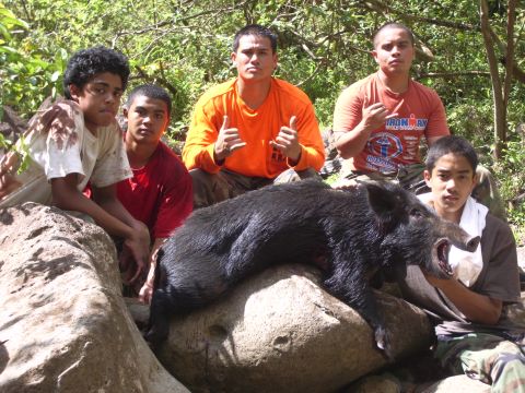 1991 Ford Bronco - A group of young men pose with a large wild boar they have hunted.