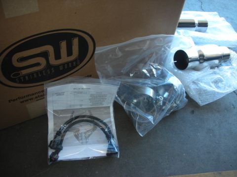 2004 Ford Crown Victoria - Unboxed Stainless Works exhaust components are laid out on a concrete surface.