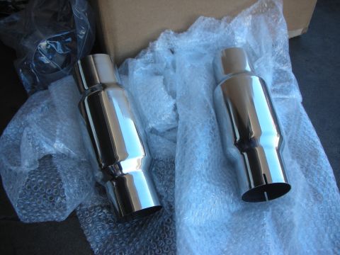 2004 Ford Crown Victoria - Two new chrome exhaust mufflers are shown, packaged in bubble wrap and a cardboard box.