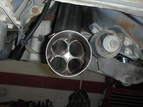 2004 Ford Crown Victoria - This photo shows the end of a custom exhaust system with four distinct openings.