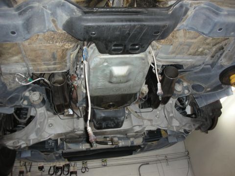 2004 Ford Crown Victoria - Aftermarket exhaust system installed on a vehicle's undercarriage.