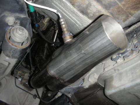 2004 Ford Crown Victoria - Close-up view of stainless steel exhaust headers and catalytic converter installed on a vehicle.