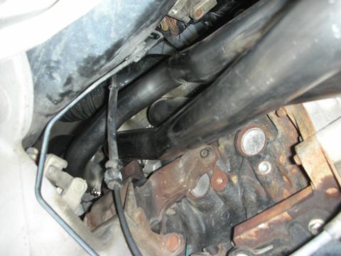 2004 Ford Crown Victoria - Underside view of engine components, focusing on exhaust headers and the engine block.