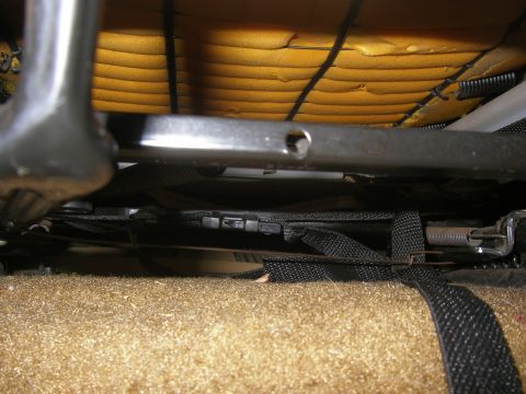 1990 Ford Bronco - Close-up view of a vehicle's seat mechanism, showing springs and straps.