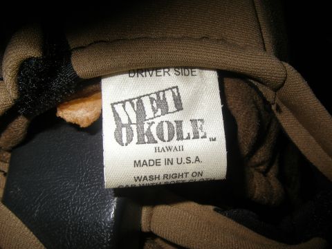 1990 Ford Bronco - A tag indicating 'Driver Side' is attached to brown fabric, with care instructions visible.