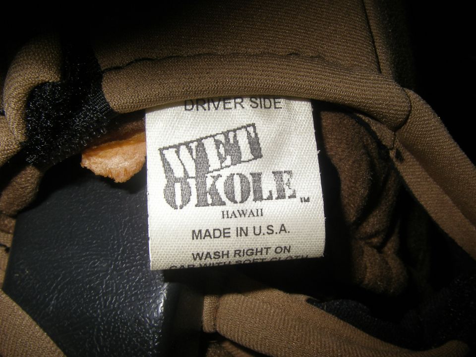 Close-up of a clothing tag that says 'Wet Okole Hawaii Made in U.S.A.' and 'Driver Side'