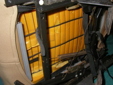 1990 Ford Bronco - Close-up view of the internal structure of a vehicle seat, revealing foam padding, springs, and metal components.