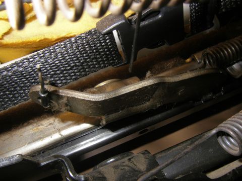 1990 Ford Bronco - Detail of a vehicle's seat slider mechanism, showing springs and metal components.