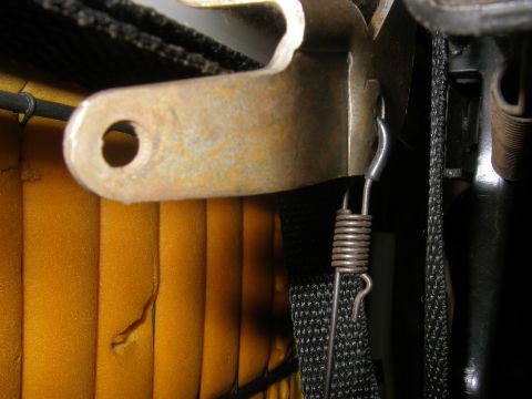 1990 Ford Bronco - Seat slider mechanism detail with spring and metal bracket.