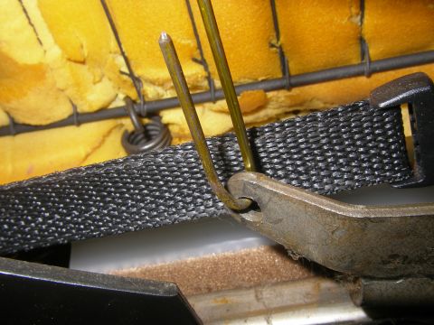 1990 Ford Bronco - Detail of a vehicle seat's internal structure, showing springs and fabric webbing.