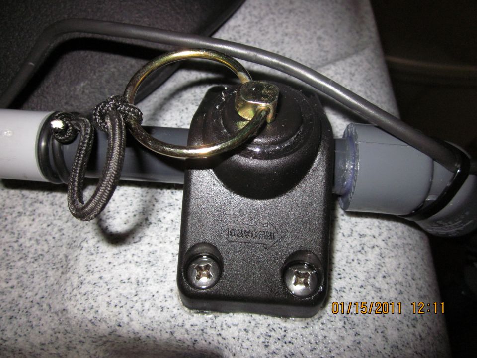 Kayak outrigger mount with a metal ring and black cord attached to a gray tube