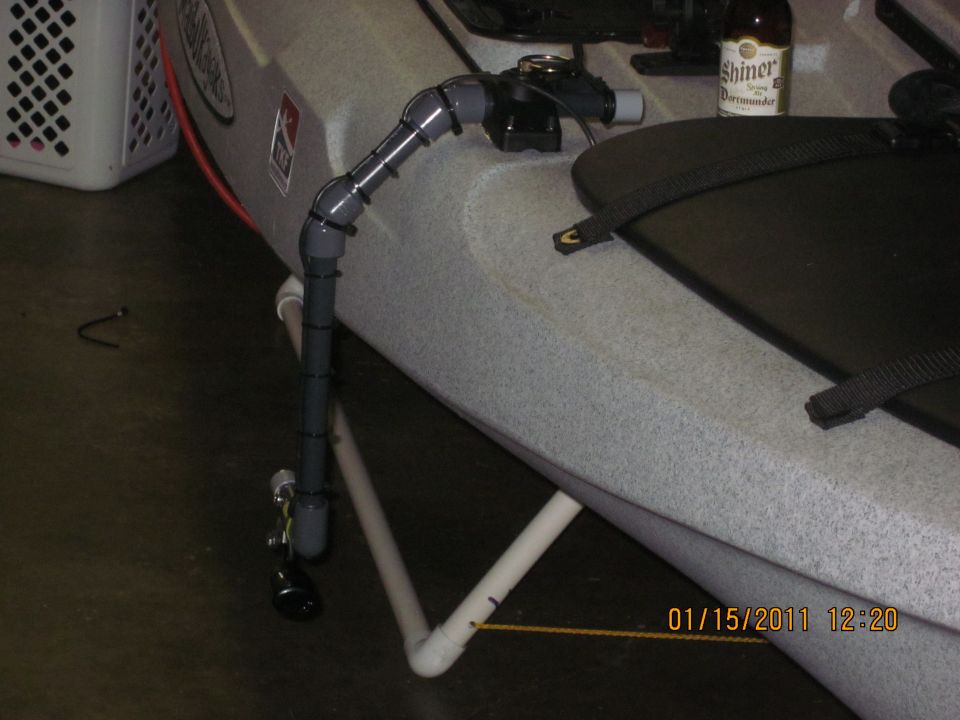Kayak with a DIY PVC pipe mount for a transducer or camera, and a beer bottle on the seat