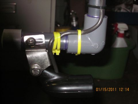 1953 Ford Mainline - A close-up view of plumbing components secured with yellow zip ties, with a black elbow fitting visible.