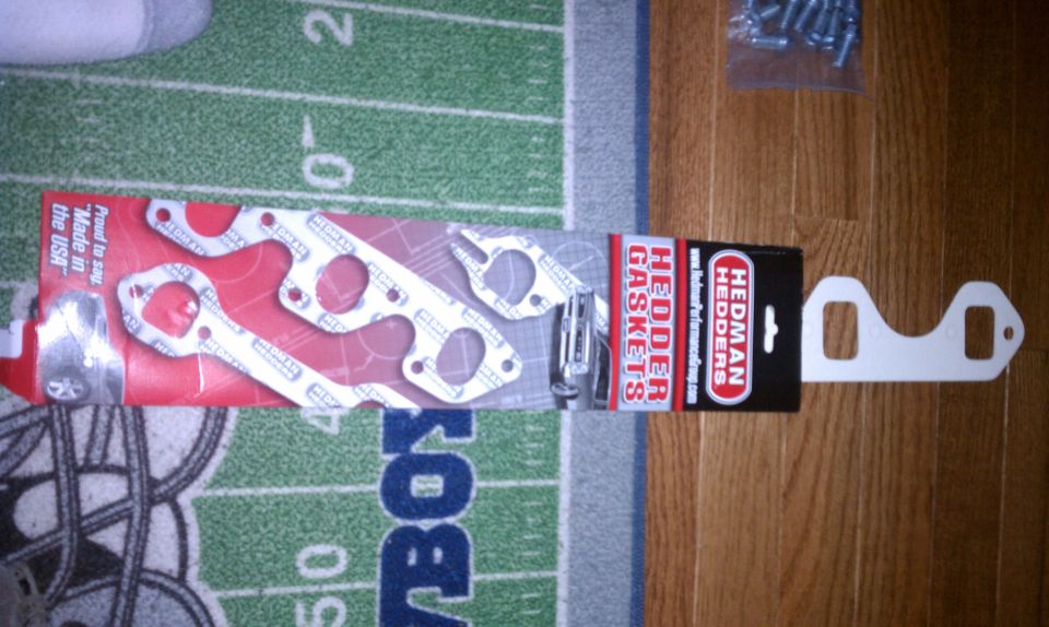 Header gaskets with Hedman Hedders branding, on a football-themed rug