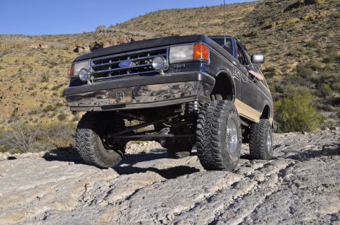 1991 Ford Bronco - This lifted 1991 Ford Bronco navigates a rocky, desert terrain.