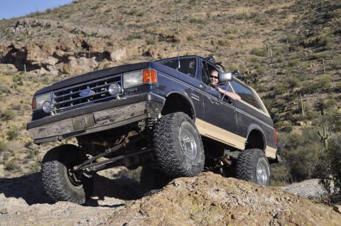 1991 Ford Bronco - This lifted Ford Bronco navigates a rocky desert trail, its off-road capabilities.