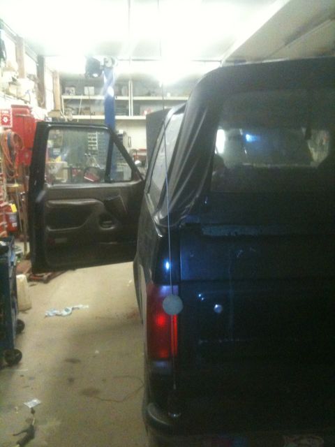 1993 Ford Bronco - This black SUV, likely a 1992 model, is parked inside a garage with its driver's door ajar.