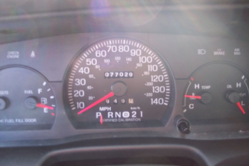 2001 Ford Crown Victoria dashboard with odometer reading 077029
