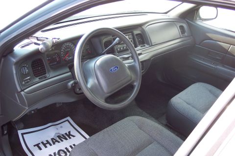 2001 Ford Crown Victoria - Interior view of a 2001 Ford Crown Victoria, the dashboard, steering wheel, and front seats.