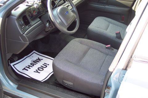 2001 Ford Crown Victoria - The interior of a 2001 Ford Crown Victoria, the driver's side dashboard and front passenger seat.