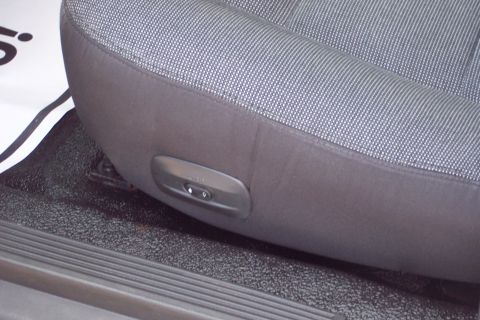 2001 Ford Crown Victoria - A close-up view of the interior of a vehicle, focusing on the seat controls.