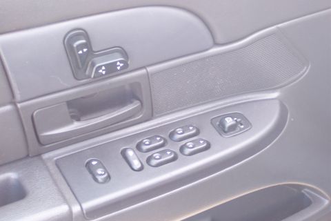 2001 Ford Crown Victoria - Interior door panel showing power window and seat controls, consistent with a 2001 Ford Crown Victoria.