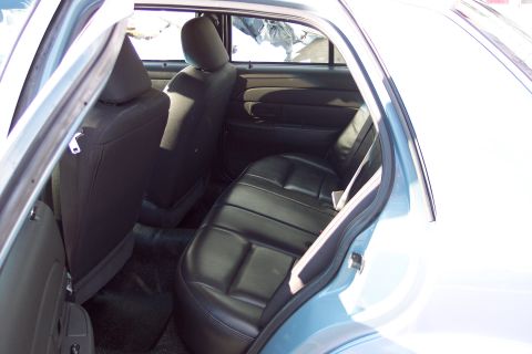 2001 Ford Crown Victoria - Interior view of the back seat and door panel of a car.