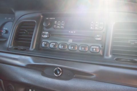 2001 Ford Crown Victoria - Interior view of a 2001 Ford Crown Victoria dashboard, highlighting the radio and climate controls.