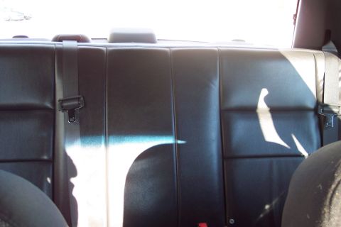 2001 Ford Crown Victoria - Interior view of a car's back seat, showing the upholstery and seatbelt system.