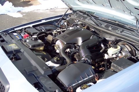 2001 Ford Crown Victoria - The engine bay of a 2001 Ford Crown Victoria is shown with the hood open, revealing the engine and surrounding components.