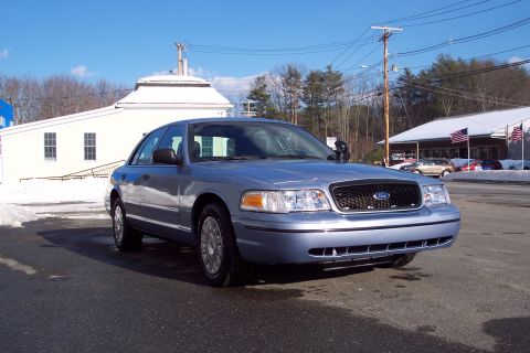2001 Ford Crown Victoria - Front view of a light blue 2001 Ford Crown Victoria police car on a sunny winter day.