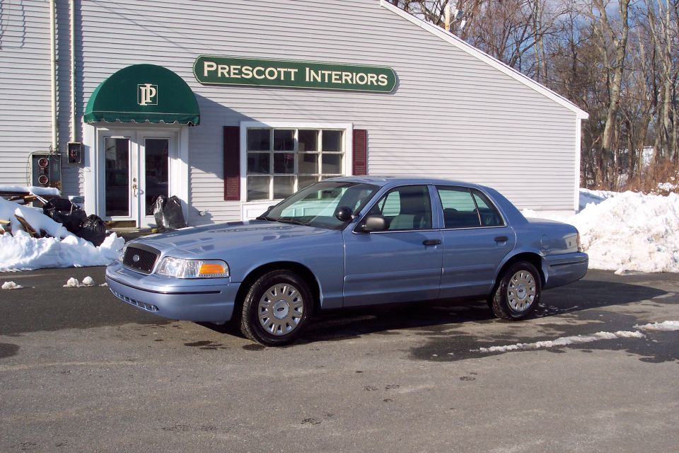 2001 Ford Crown Victoria parked outside Prescott Interiors building
