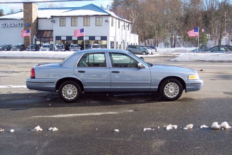 2001 Ford Crown Victoria - Side view of a 2001 Ford Crown Victoria sedan parked in a lot during winter.