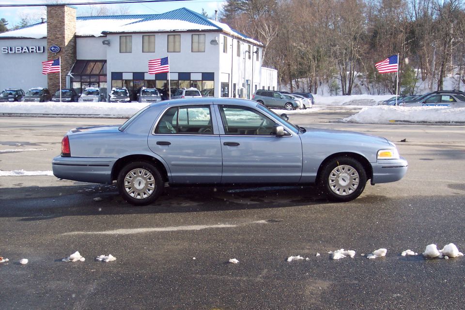 2001 Ford Crown Victoria sedan, side view, parked in a lot with snow on the ground